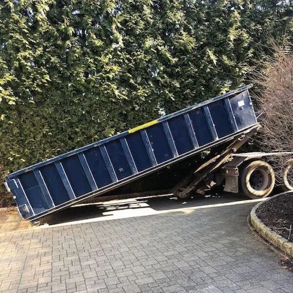 In Annapolis MD a 20 yard roll-off dumpster being delivered into a driveway