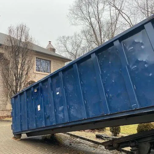 Large roll off bin being placed on property