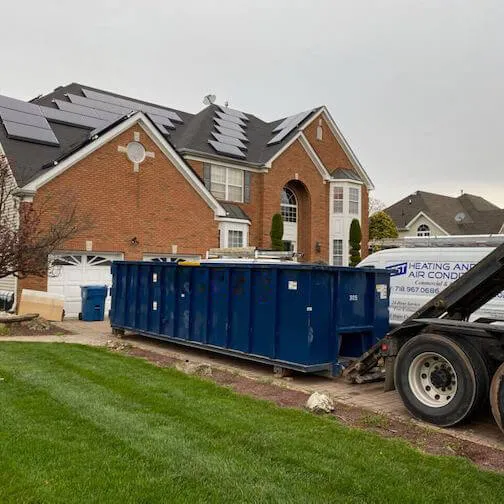 Image of roll off dumpster being delivered to home