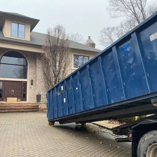 Image of medium dumpster being lowered onto property 