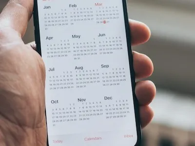 man holding phone with calendar pulled up