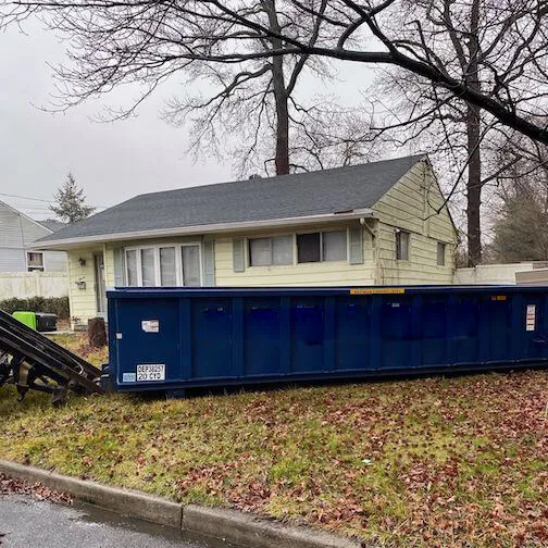 Image of dumpster on lawn with leaves