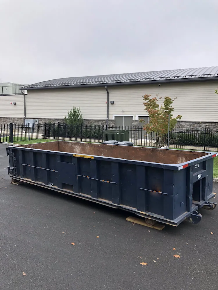 Image of a dumpster inside a property gate