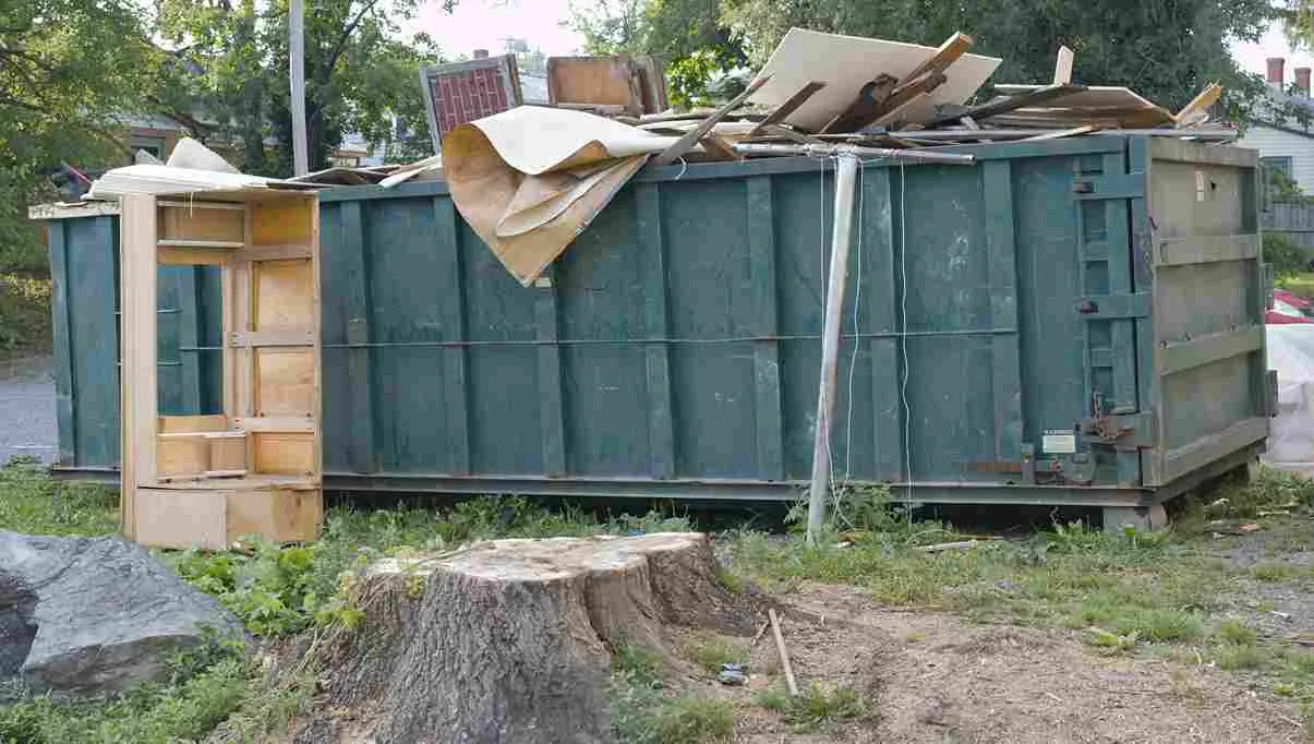 Dumpster full of wood and cardboard materials