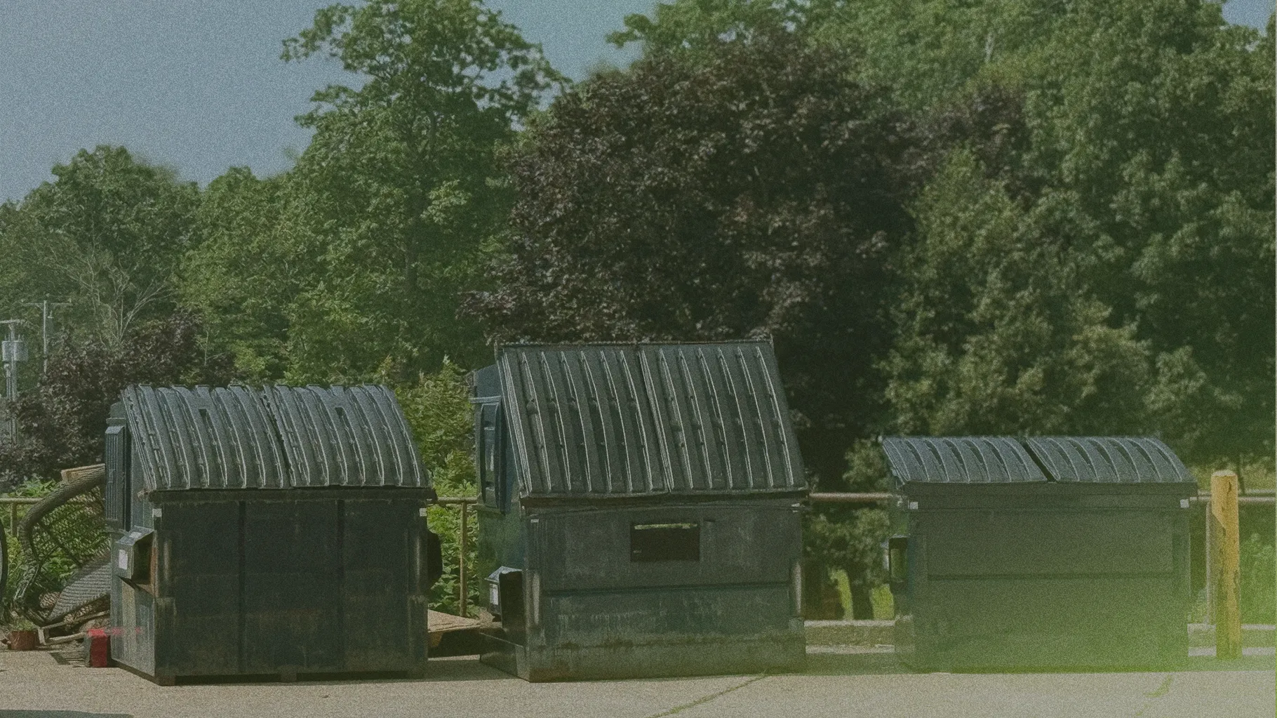 three dumpsters of different sizes