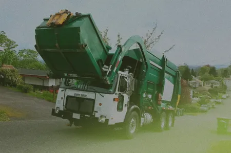 truck picking up a dumpster