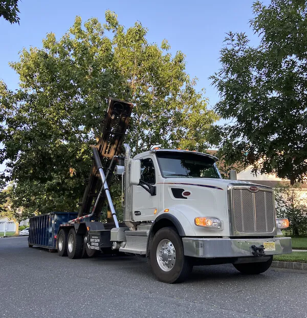 Dumpster offloading blue bin in Duval County Florida