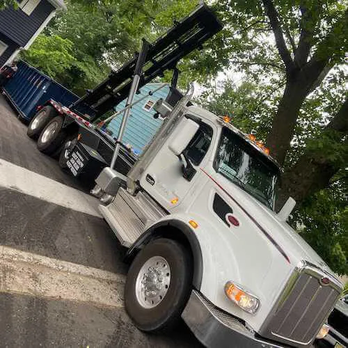 Roll off truck delivering a dumpster in a driveway in Gettysburg PA