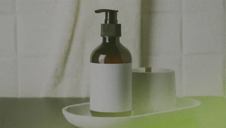 Brown pump bottle with a blank label on a white tray, next to a cylindrical container, against a tiled background.