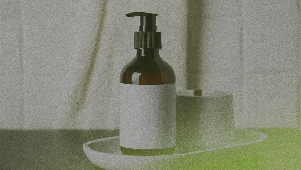 Brown pump bottle with a blank label on a white tray, next to a cylindrical container, against a tiled background.