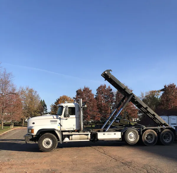 Picture of an offloaded dumpster truck on a street