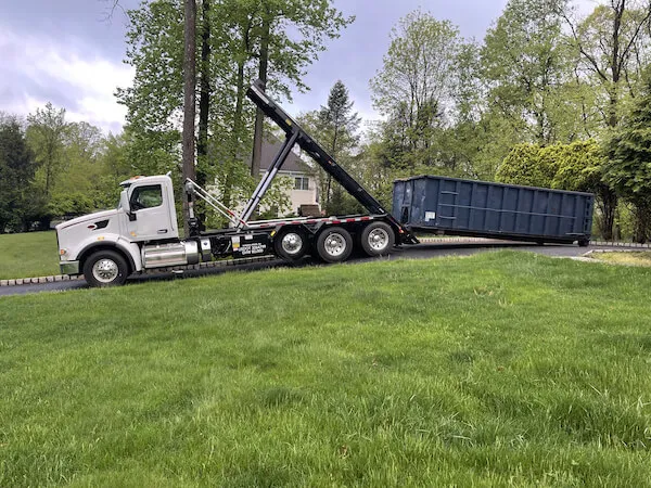 Roll off dumpster being delivered in a driveway in Kent County DE