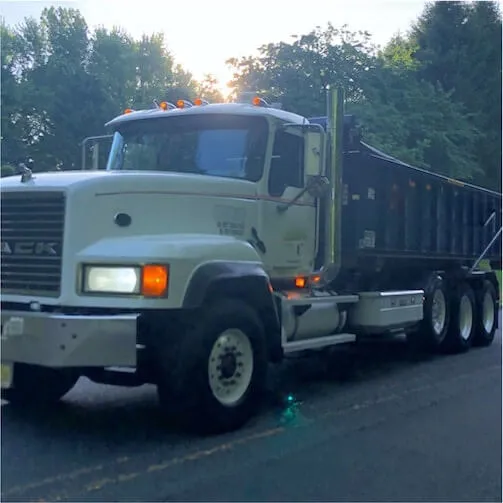 Picture of roll off mack truck with bin on it 