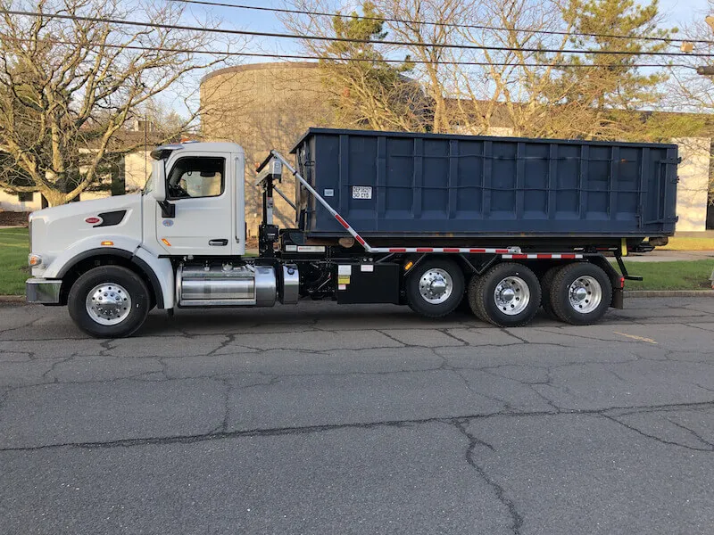 Roll off dumpster on a truck in the street in Manassas VA