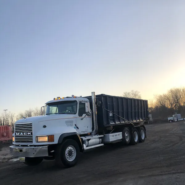 30 yard dumpster on a roll off truck in the sunrise 