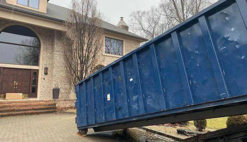 Large roll off bin being delivered to house