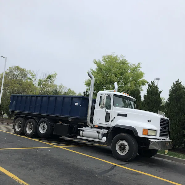 Roll-off dumpster truck with a 20 yard dumpster in a parking lot in North Carolina