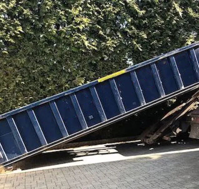 A blue 20 yard dumpster being delivered in Orange County FL