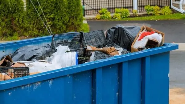 Dumpster full of trash and discarded items 