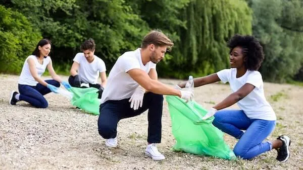 Volunteers cleaning up trash on beach 