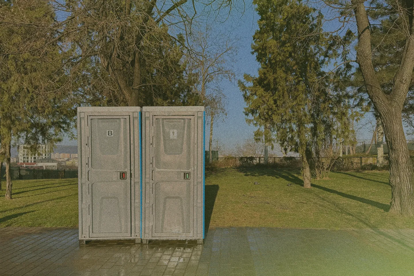 two porta potties in a park