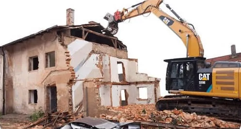 Image of a house being demolished by crane 