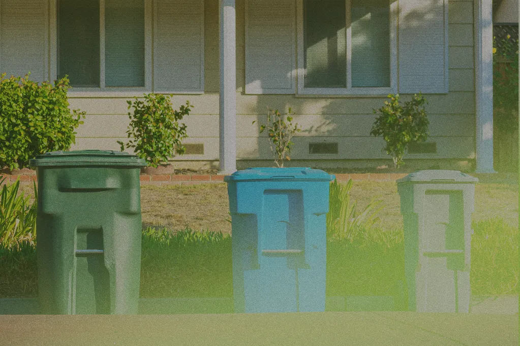 garbage cans on the street outside a house