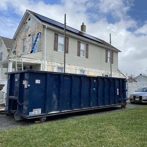 A 30 yard dumpster next to a solar panel house in Lehigh County PA