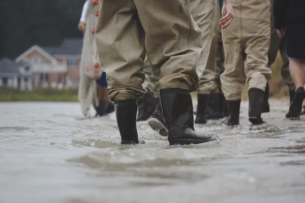 Picture of people walking through flooded street