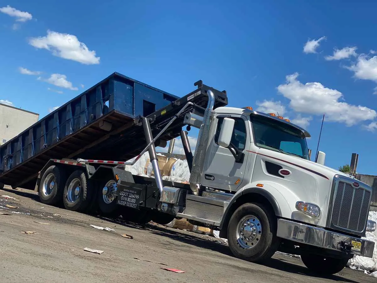 dumpster truck dropping off bin 