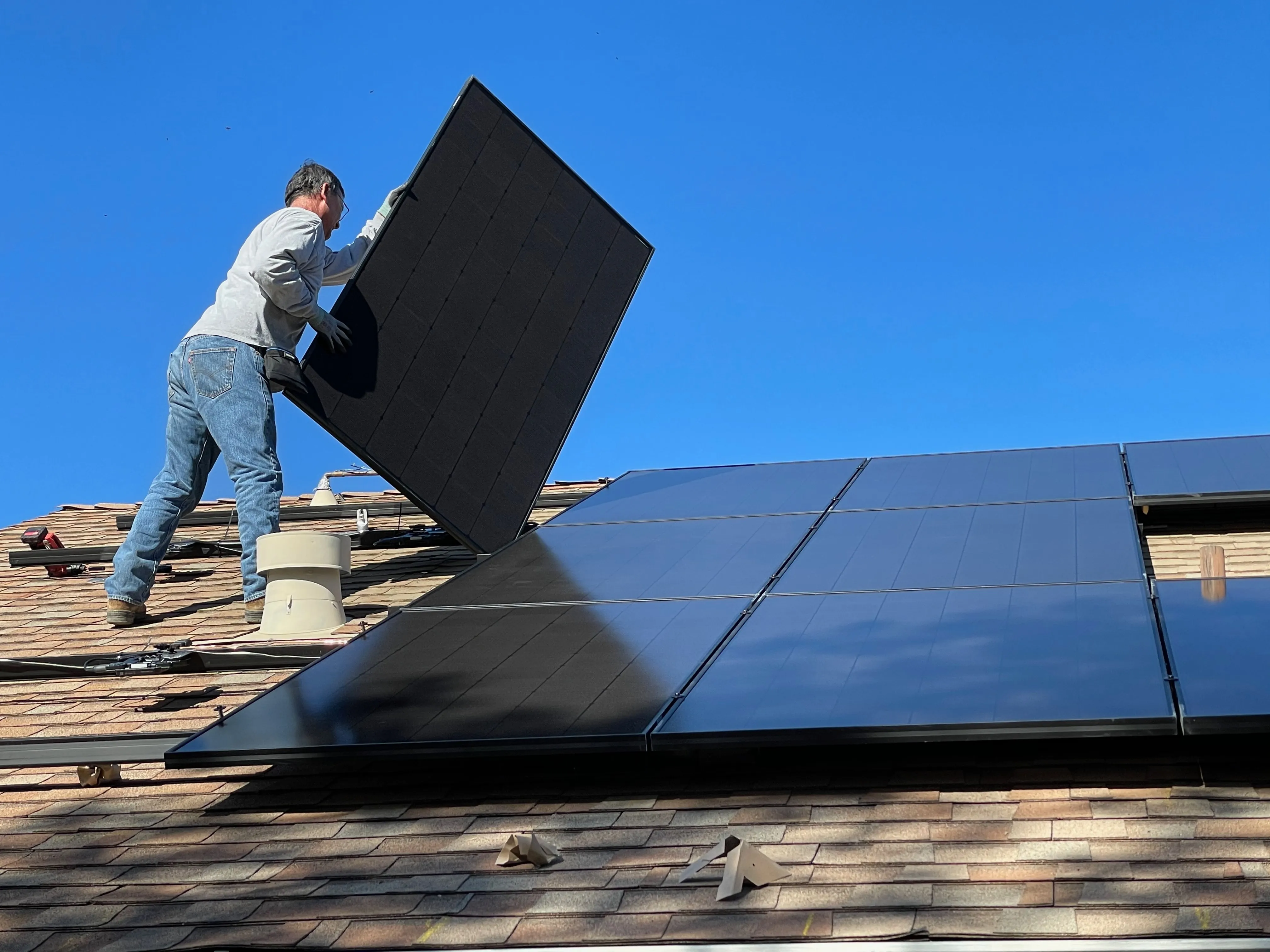 roofer installing solar panels 