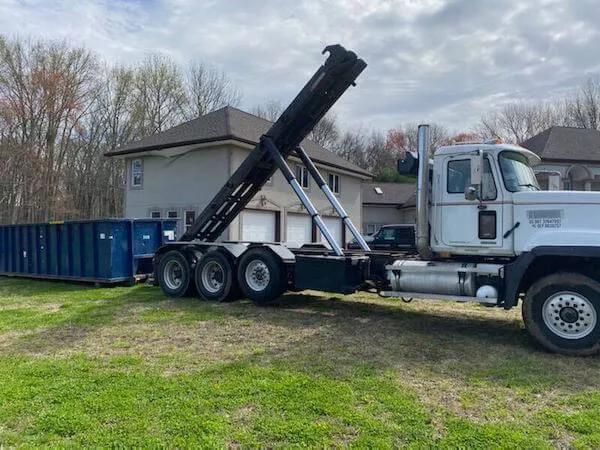 Image of a dumpster being delivered after a storm 