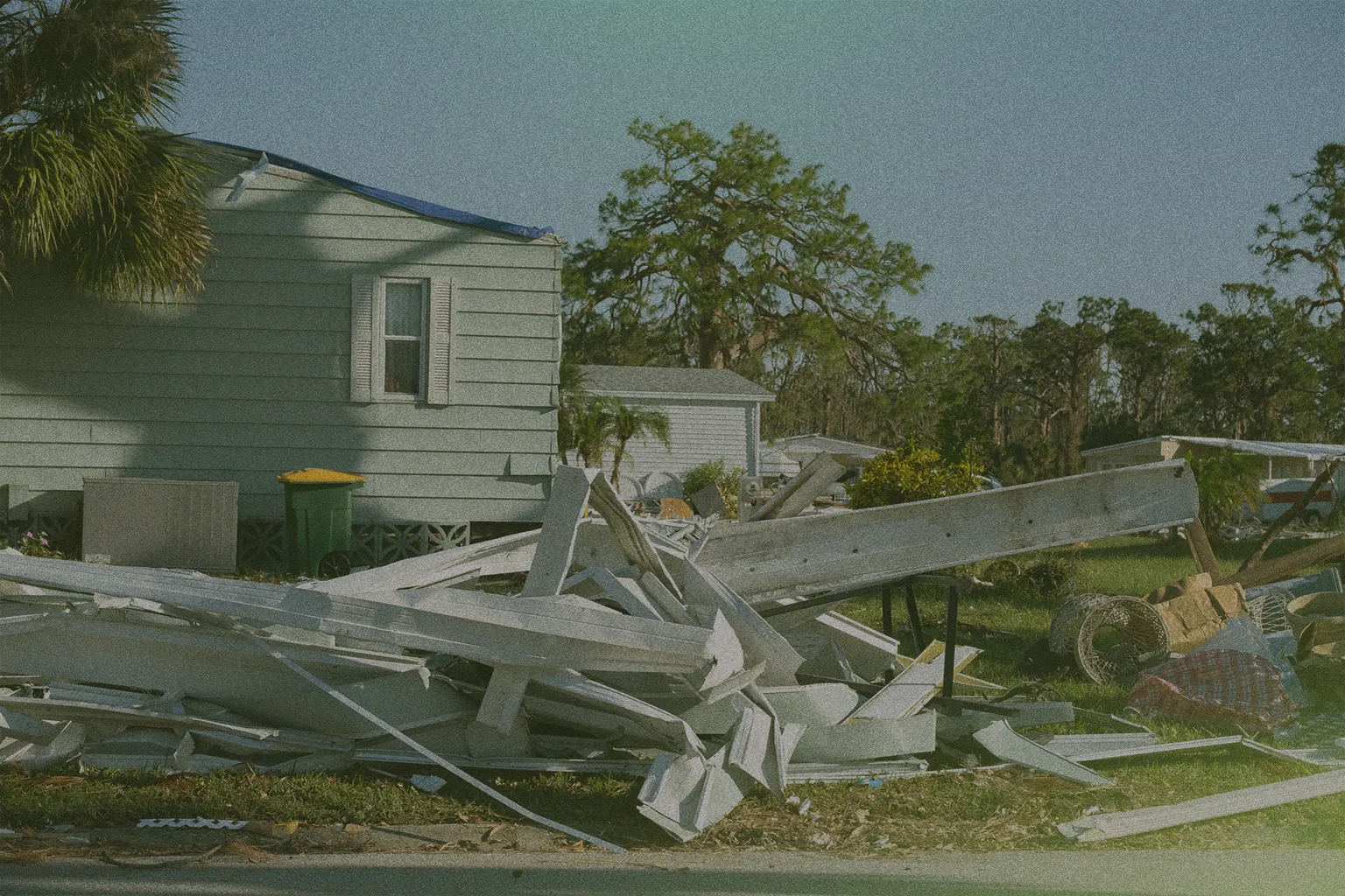 debris in front of a house after a storm