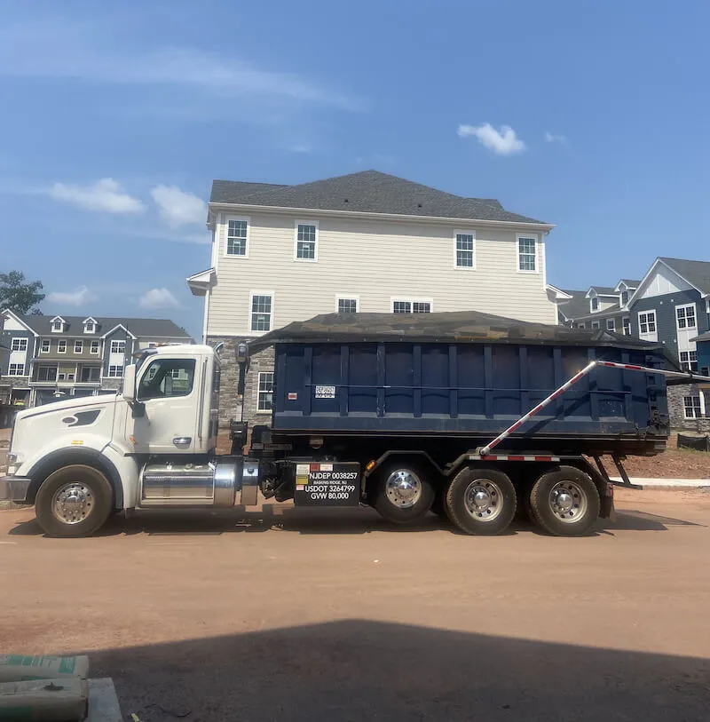 image of truck filled with wood outside of residence 