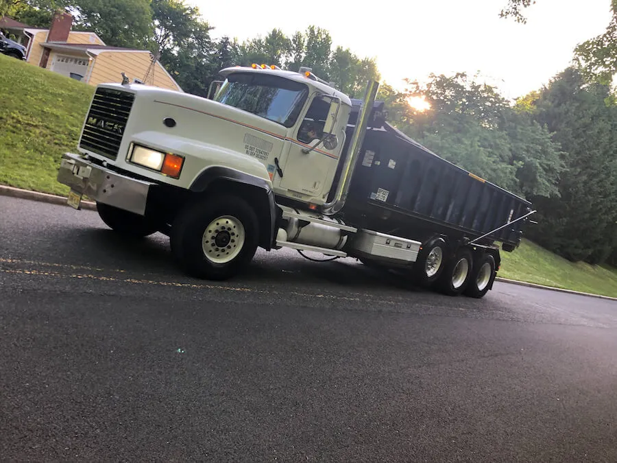 Image of roll off truck delivering dumpster 