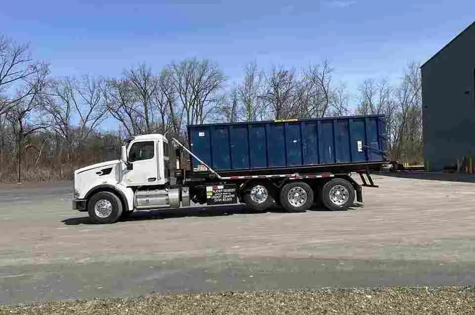 Truck with roll off bin on back in New Jersey