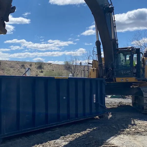 A machine loading a dumpster in Virginia Beach VA