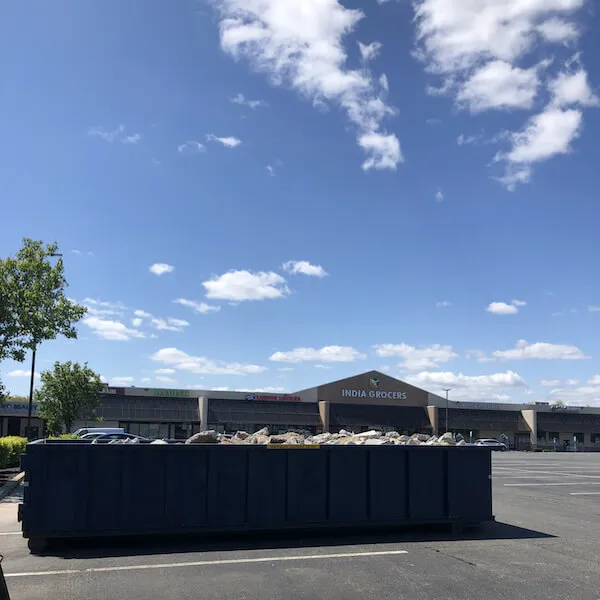 20 yard dumpster with concrete in parking log in Wake County NC