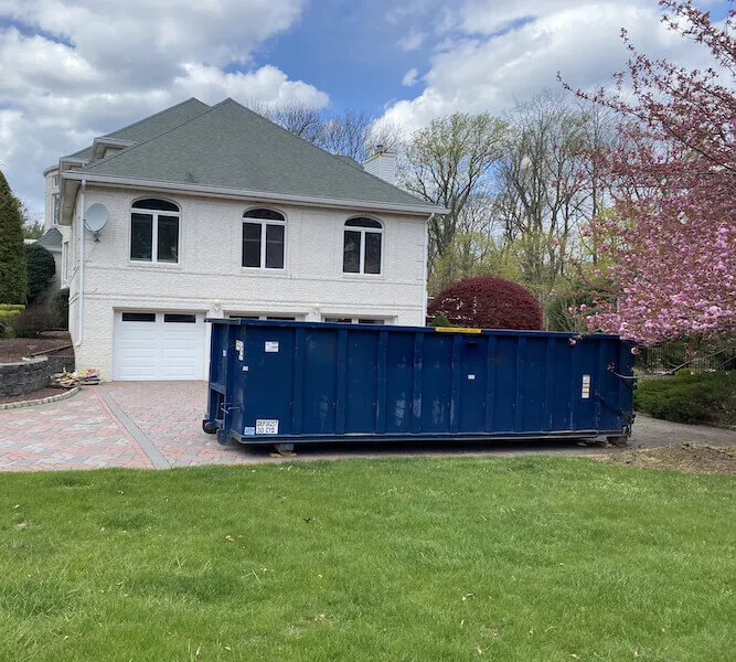 A blue 30 yard dumpster in a driveway in Washington DC